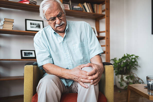istock Senior man experiencing knee pain at home 2223524462