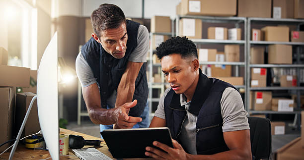 istock Men, explain and tablet for warehouse distribution of inventory management, online order and stock. People, computer and advice of supply chain, quality control and information with delivery schedule 2223526152