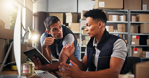 istock Logistics, people and computer with tablet for discussion, checking stock and inventory research. Team, men and supply chain manager with feedback to monitor distribution, order or business in office 2223526163