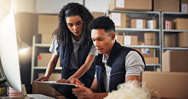 istock Logistics, business people and teamwork with tablet for talking, check stock or inventory research. Collaboration, man or woman with tech to monitor distribution, supply chain or discussion in office 2223526170