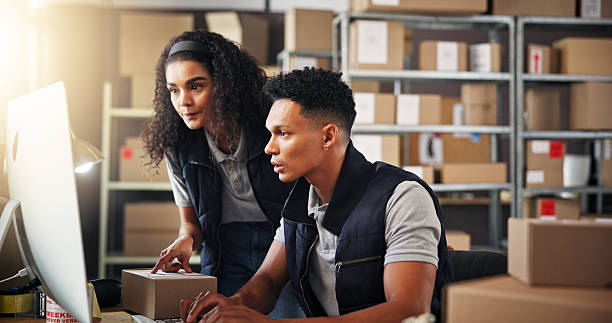istock Supply chain, business people and teamwork with computer for service, check stock and inventory research. Collaboration, woman and man with tech to monitor distribution, logistics or typing in office 2223526176