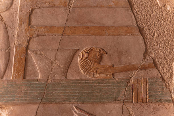 Intricate horus falcon hieroglyph carved on a wall, symbolizing the egyptian god in an ancient temple