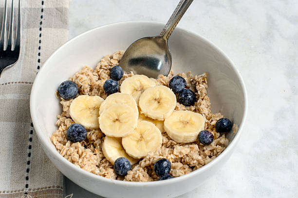 istock oatmeal top with bannanas and blue berries 2223528317
