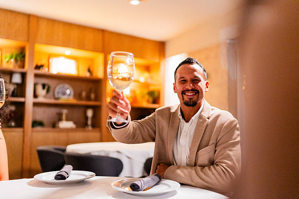 istock Mid adult man toasting wine with friends on restaurant 2223528721