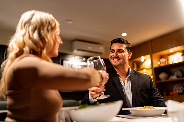 istock Couple talking and toasting wine at restaurant 2223529365