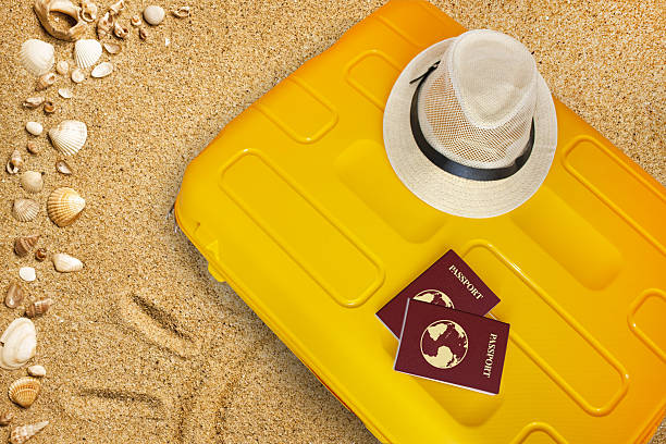 istock Suitcase for vacation, packing a suitcase, passport, hat, sand, sea 2223529386