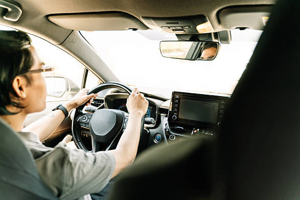 istock Young man driving modern car on sunny day 2223529864