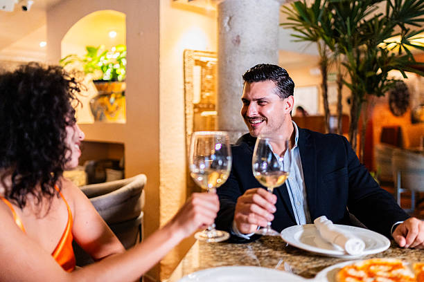 istock Couple talking and toasting wine at restaurant 2223530255