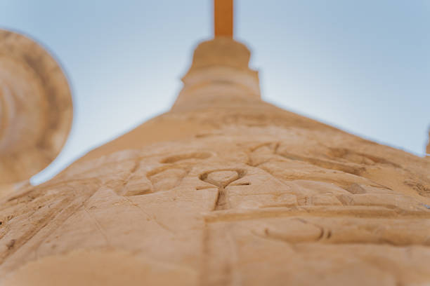 Low angle view of hieroglyphs carved into an ancient egyptian column at karnak temple