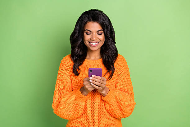 istock Portrait of attractive focused cheerful girl using device browsing web app 5g isolated over green pastel color background 2223531284