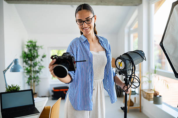 istock Photographer Setting up Professional Lighting in a Modern Studio Environment 2223531477