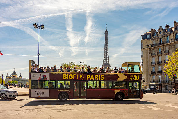 Paris, France - 06 April 2025: Sightseeing bus and Eiffel tower at background