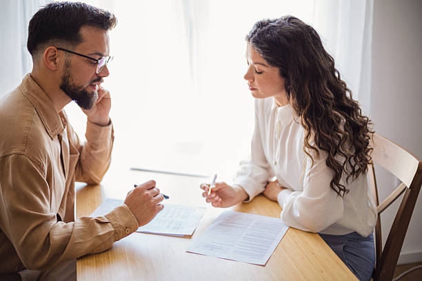 istock Couple reading and discussing documents at home 2223535653