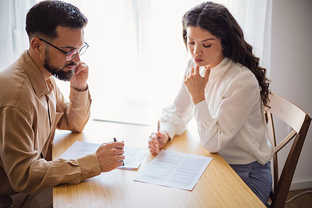 istock Focused colleagues collaborating on documents at office table: teamwork and productivity 2223535688