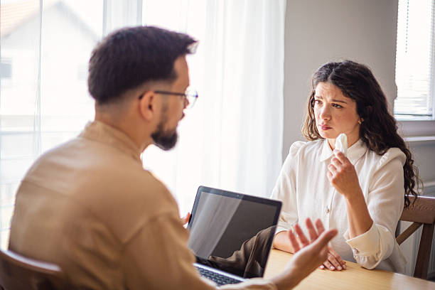 istock Psychologist comforting crying woman during therapy session 2223536142