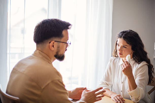 istock Psychologist comforting sad patient during therapy session 2223536319