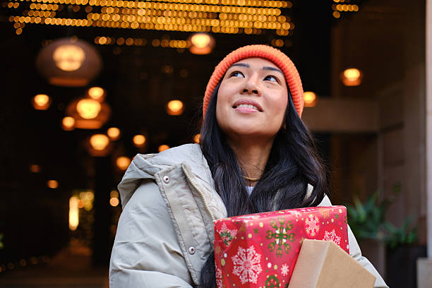 headshot of Young asian woman enjoying christmas shopping in barcelona stock photo