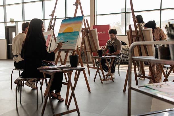 istock Diverse Students Painting in Art Class with Teacher Mentoring 2223537494