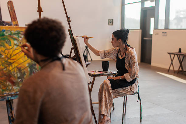 istock Focused artists painting on canvas during art lesson 2223537861