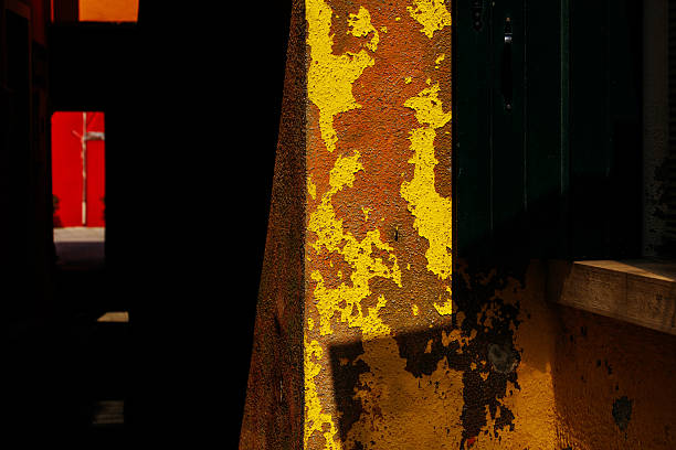 istock Vibrant urban peeling paint on sunlit walls with shadow play 2223537954