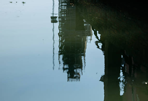 Reflection of industrial construction structure on calm water surface, lifestyle concept