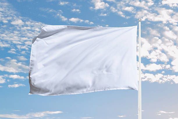 istock White flag stretches with movement in open sky, ideal for peaceful concepts, surrender symbolism, or minimalist branding presentations 2223539619