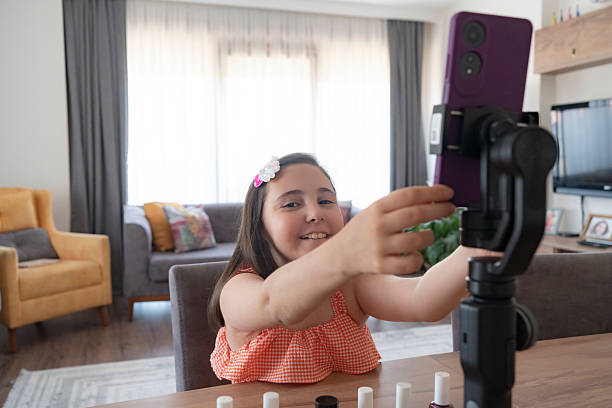 istock A talented young girl is showing cosmetic products while recording her make up tutorial 2223539816