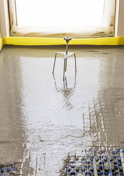 istock Liquid concrete is poured over floor heating installation in a new building. Modern construction system 2223540956