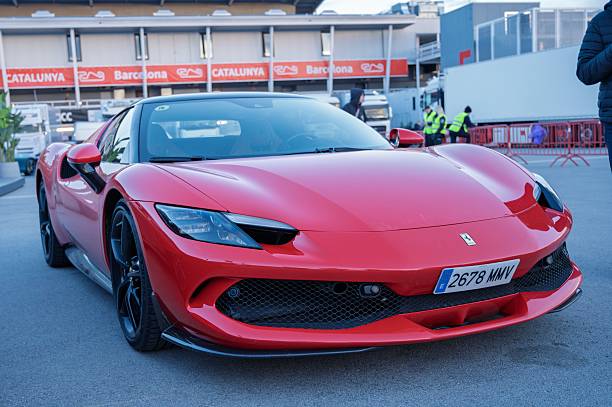 Montmelo, Spain – March 22, 2025: Front view of a stunning red Ferrari 296 GTS luxury supercar, parked outdoors at a venue in Catalunya, Barcelona.