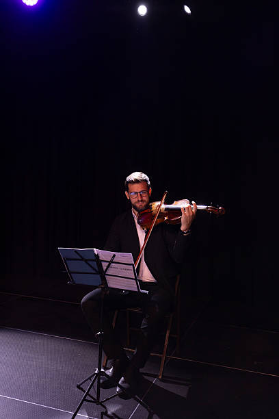 istock A male musician elegantly plays the viola. His expression reflects passion and concentration, highlighting the art of music and personal expression 2223543366