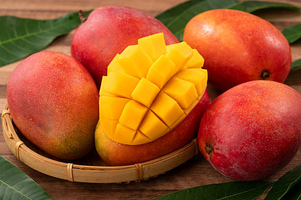 istock Fresh ripe mango with cubes on wooden table background. 2223545770