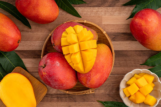 istock Fresh ripe mango with cubes on wooden table background. 2223545952