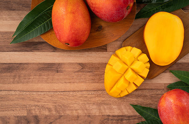 istock Fresh ripe mango with cubes on wooden table background. 2223545954