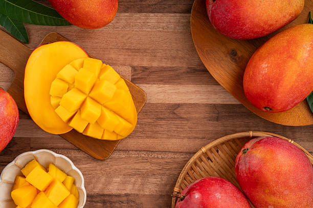 istock Fresh ripe mango with cubes on wooden table background. 2223546053
