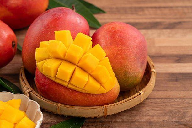 istock Fresh ripe mango with cubes on wooden table background. 2223546104