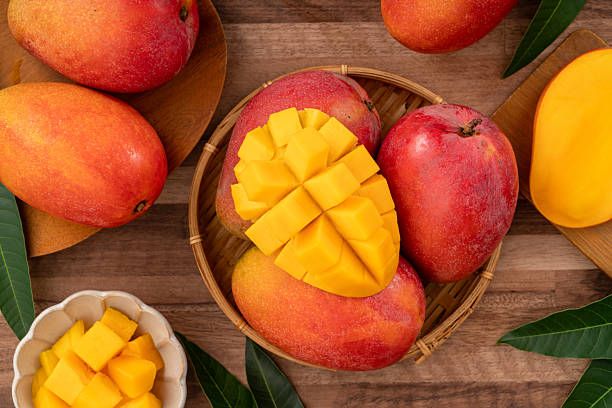 istock Fresh ripe mango with cubes on wooden table background. 2223546112