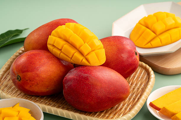 istock Fresh ripe mango with cubes on green table background. 2223546116