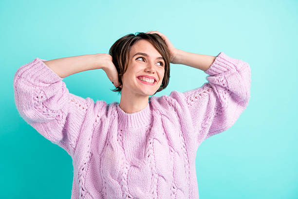 istock Photo of funny adorable young lady dressed purple pullover arms head looking empty space isolated teal color background 2223547276