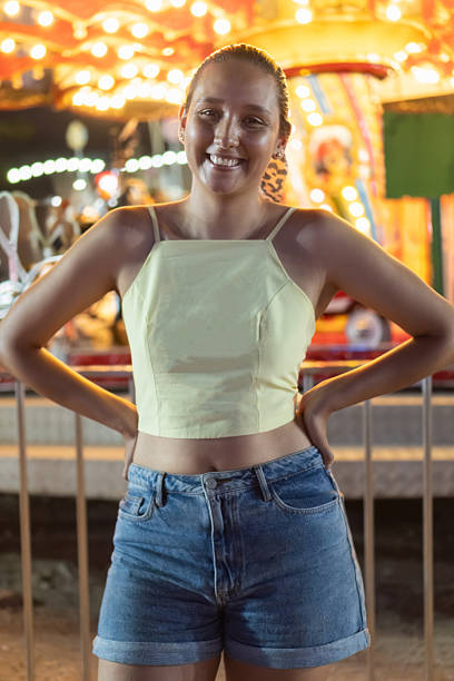 istock Smiling young woman enjoying carnival lights 2223548163