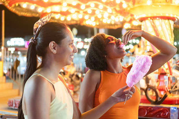 istock Friends enjoying cotton candy at a carnival 2223548436