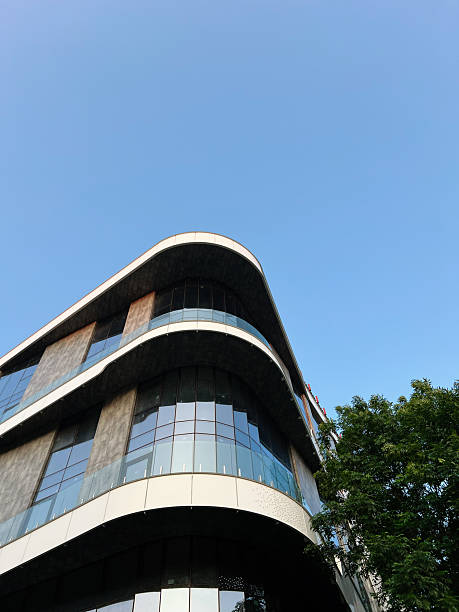 istock Modern building with curved architectural design under clear blue sky 2223550276