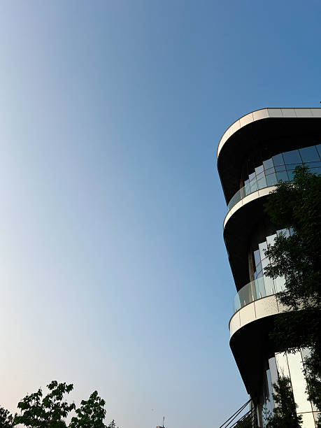 istock Modern architecture building with greenery against a clear blue sky backdrop 2223550338