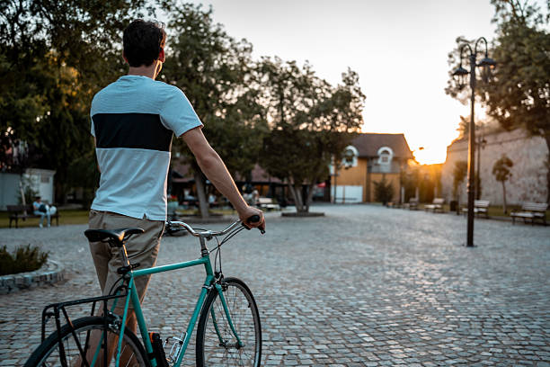 istock Male Cyclist Enjoying a Leisurely Ride in a Serene Urban Setting 2223550910