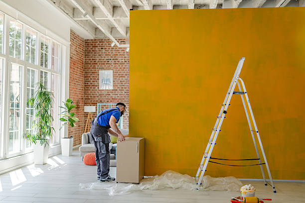 istock House painter working on a vibrant yellow wall in a modern living space during a home renovation project 2223552920
