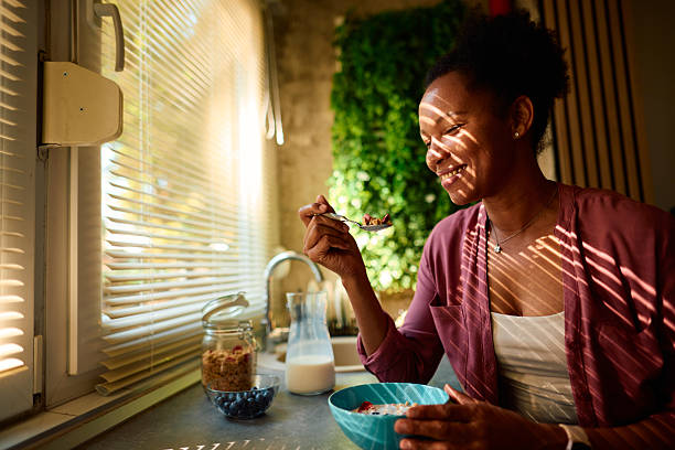 istock Young woman enjoying a healthy breakfast in her modern kitchen 2223553921