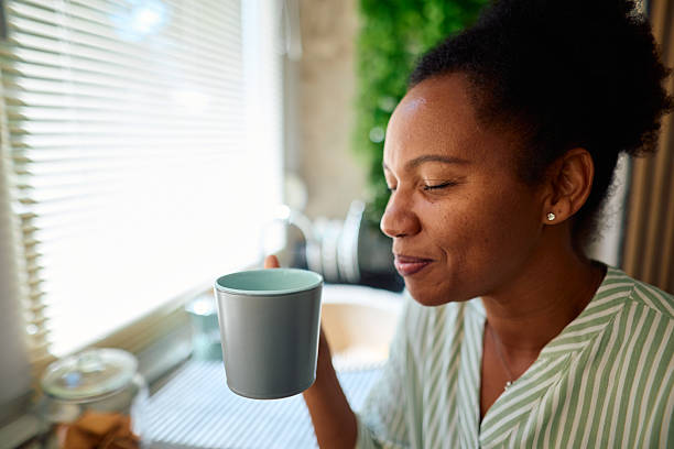 istock Serene woman enjoying a hot beverage in her kitchen 2223554311