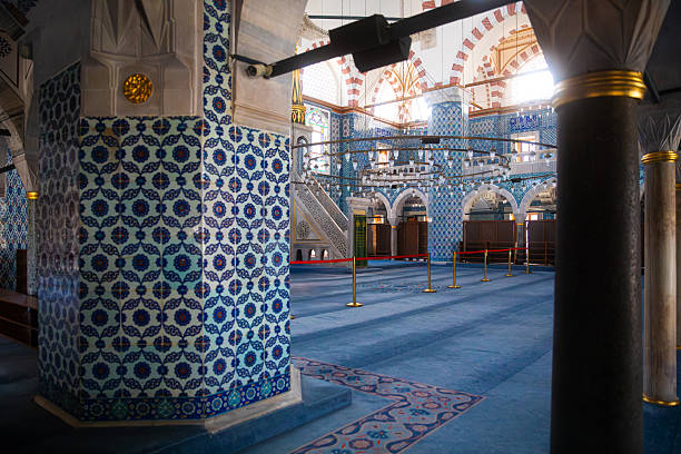 Detailed view of the Rustem Pasha Mosque in Istanbul, Türkiye, showcasing elegant Ottoman architecture, decorated arches, marble columns, Iznik tiles, and Arabic calligraphy. The composition captures the peaceful ambiance and refined artistry typical of classical Islamic religious spaces. Ideal for themes related to architecture, history, religion, and cultural heritage.