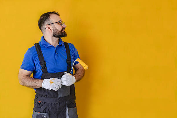 istock House painter preparing to apply bright yellow paint on a wall in a modern indoor space 2223555001