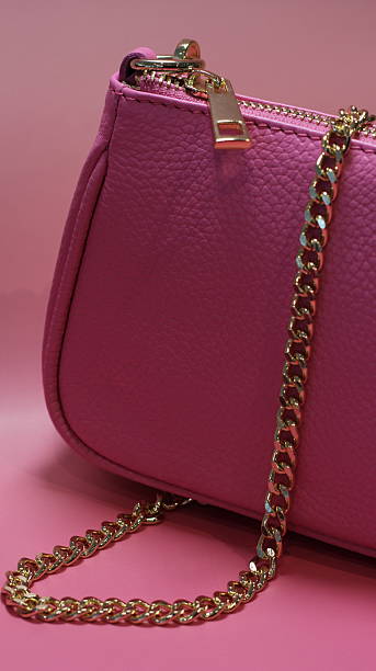 istock pink clutch bag on a pink background 2223556908