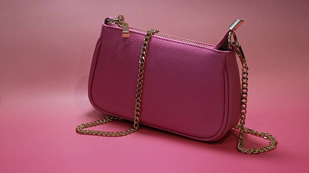 istock pink clutch bag on a pink background 2223556931